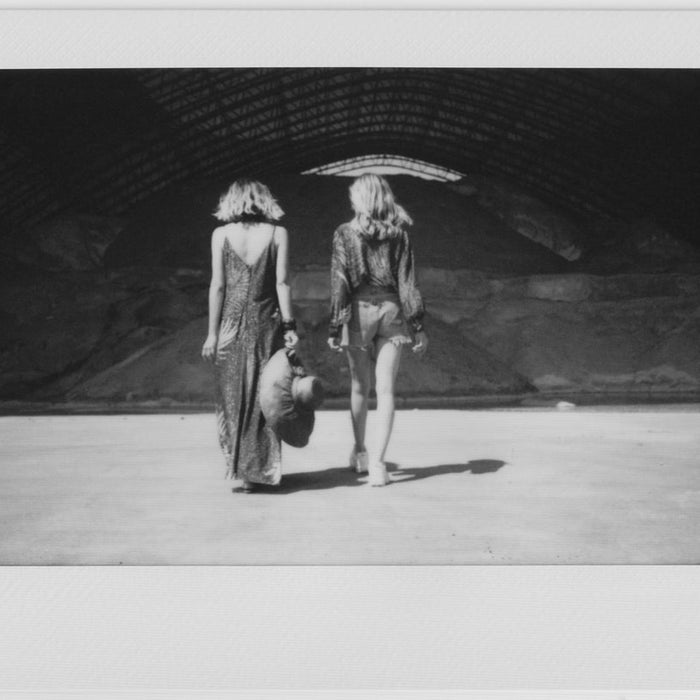 polaroid of models walking away form camera.