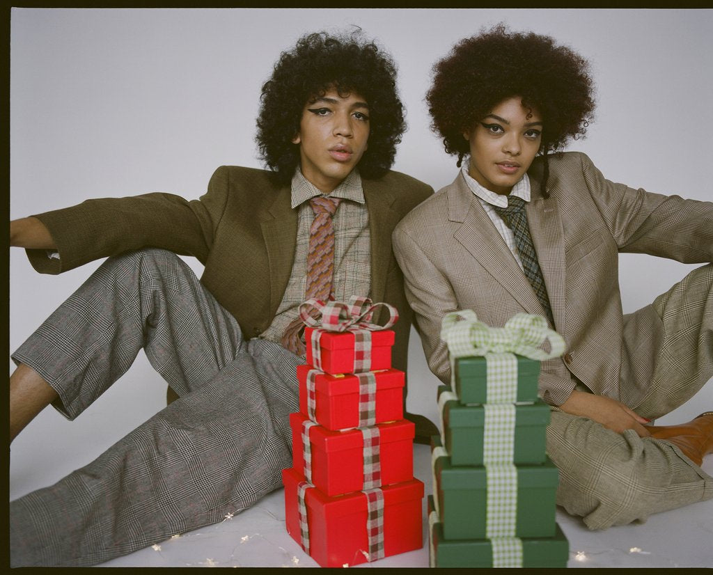 two models in suiting and presents.