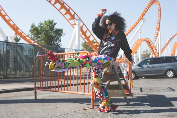 model wearing stuff toys sewn on pants.