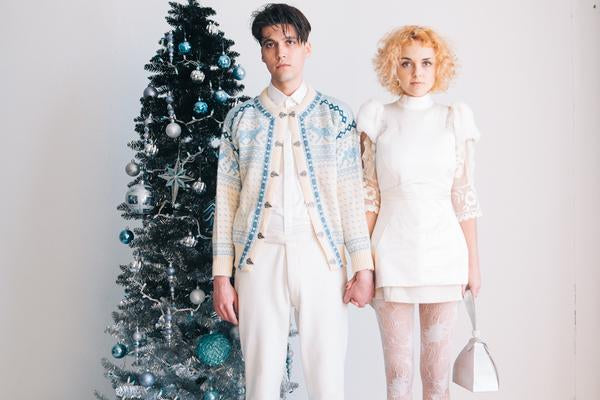 models pose in front of christmas tree.