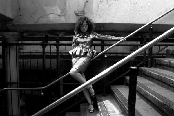 model posing on stairs of train station