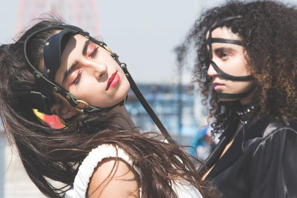portrait of models in bdsm inspired headgear.