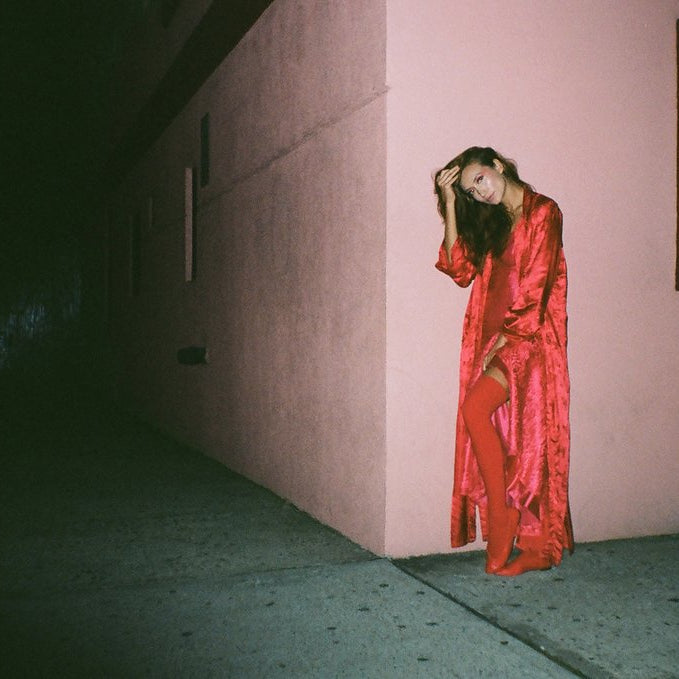 model posing on corner of building.
