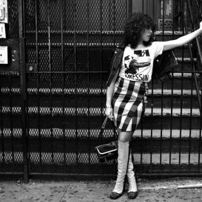 model leaning on fence.