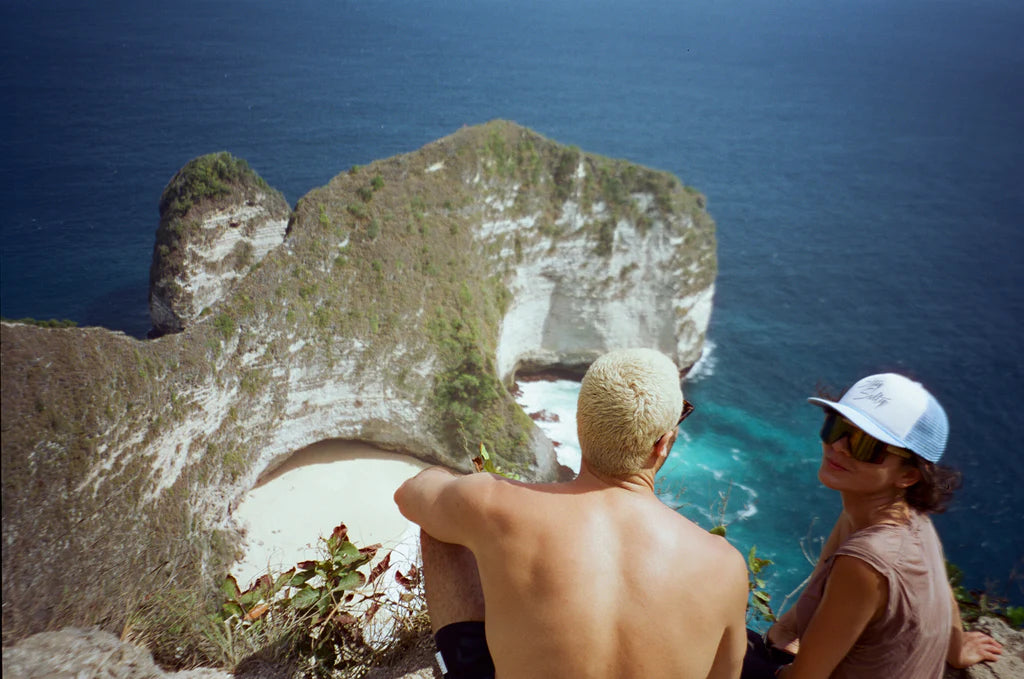 aisha looking at camera and friend at top view at kelingking beach.