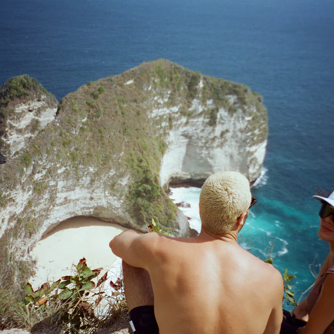 aisha looking at camera and friend at top view at kelingking beach.