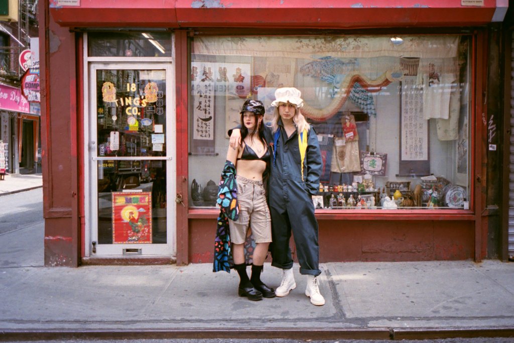 models posing in front of store front 18 ting co.