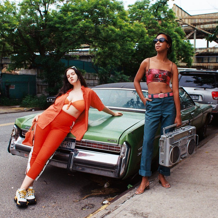 models posing on vintage car with boom box. 
