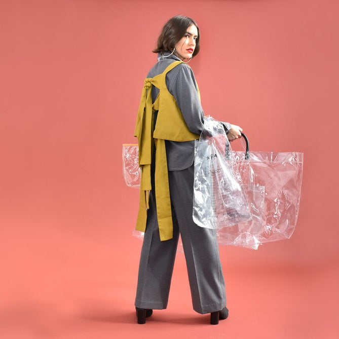 model with a collection of clear bags. 