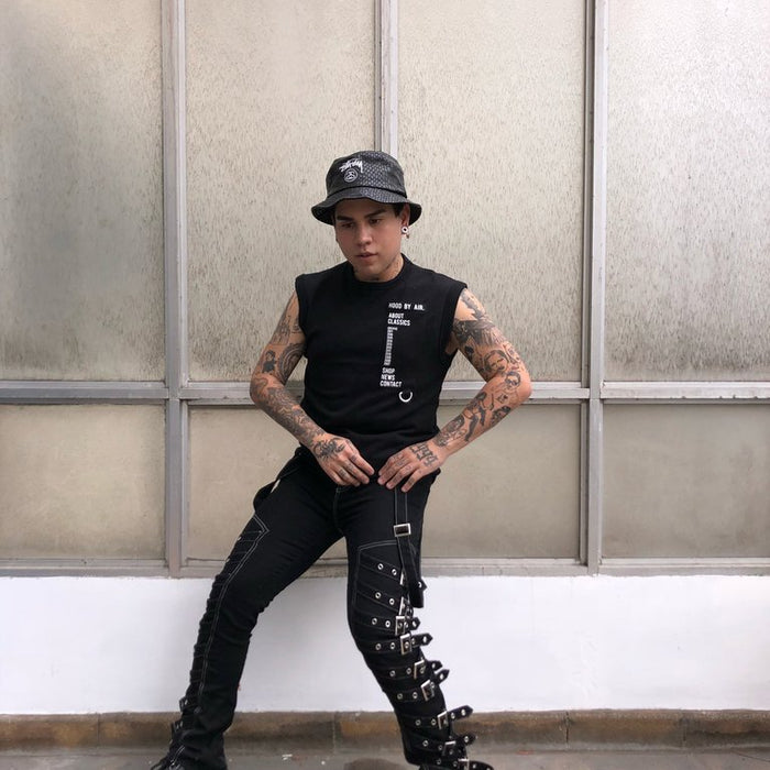 diego in 'hood by air' with 'about classics', 'shop', 'news', 'contact' text tank and 'stussy' bucket hat in front of glass wall.