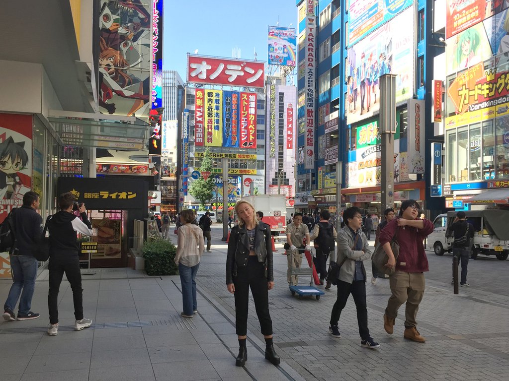 person standing in the middle of the streets in tokyo. 