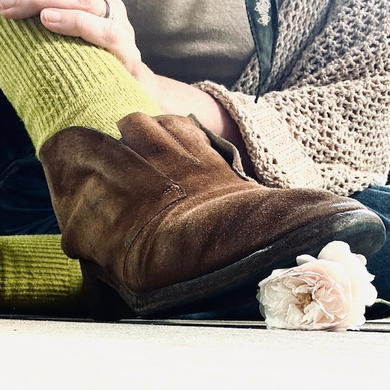 brown boot, yellow sock, squishing a ivory rose