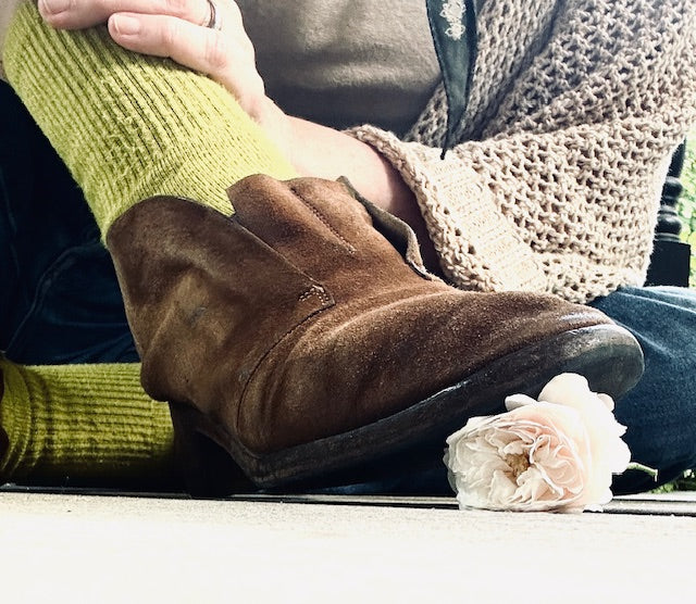brown boot, yellow sock, squishing a ivory rose