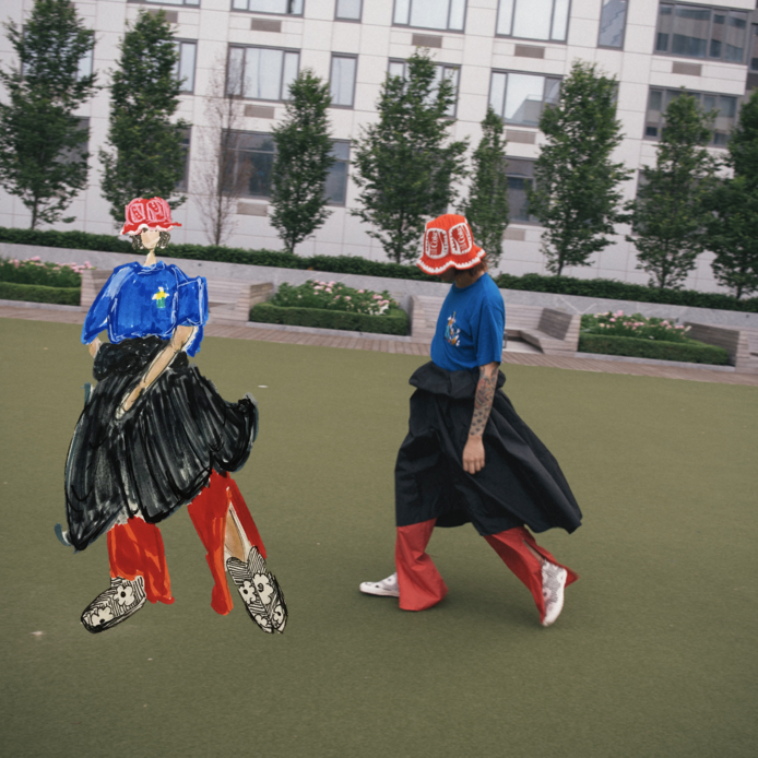 rao in city park in t-shirt, skirt, pants, and crochet bucket hat with drawn rendering of themself.