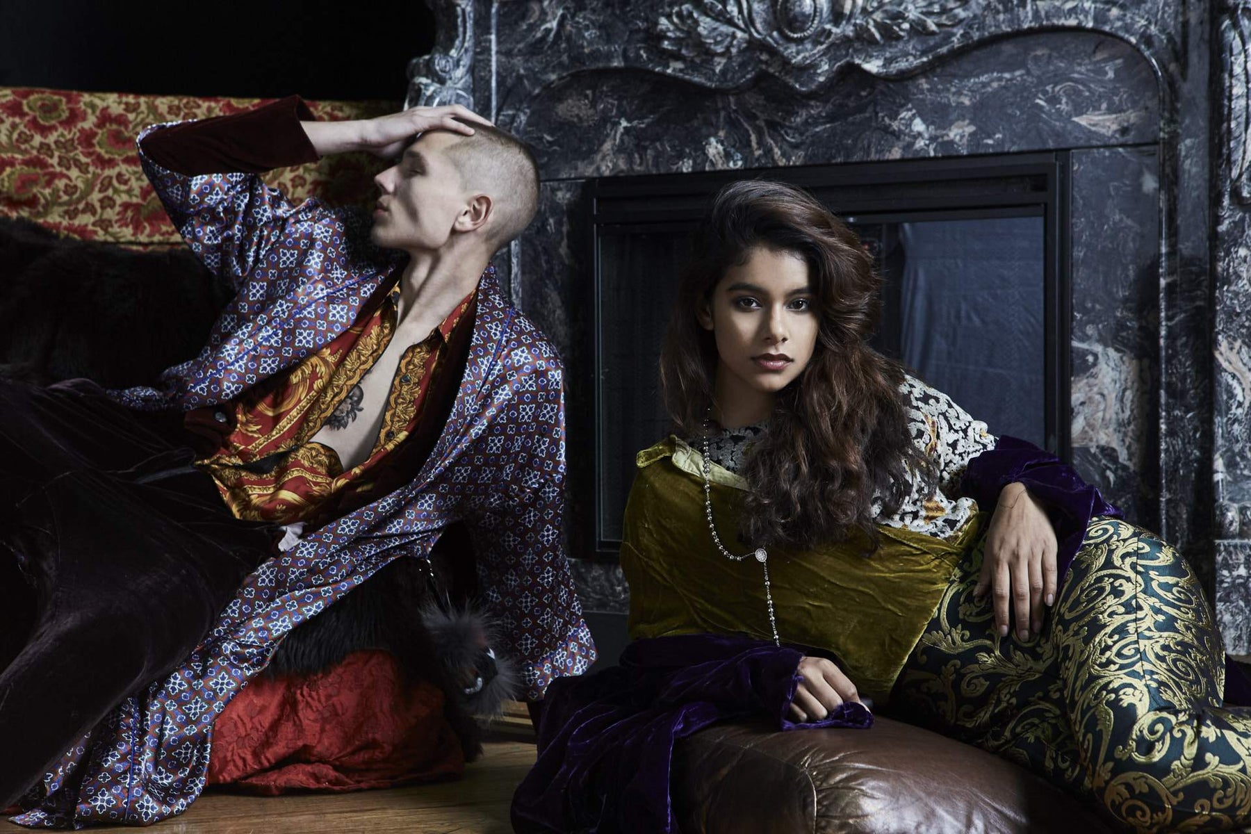 models posing in mixed prints lounging in front of a fire place