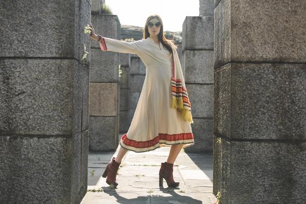 model posing in folk inspired dress.