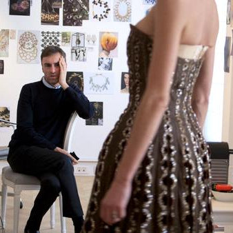 still frame of designer and model from movie.