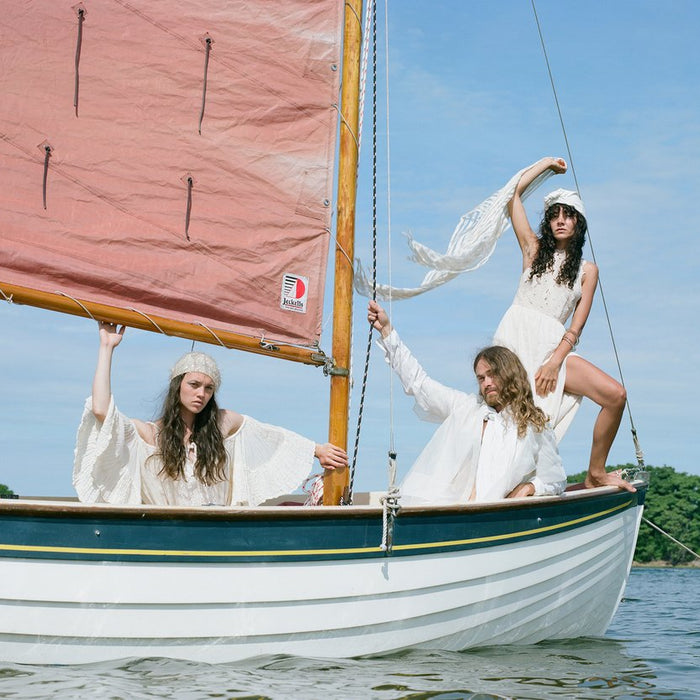 three models on sail boat.