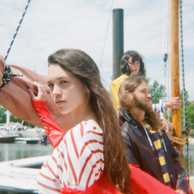 three models on a sail boat.