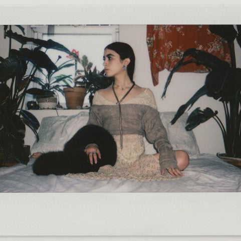 alex posing on their bed.