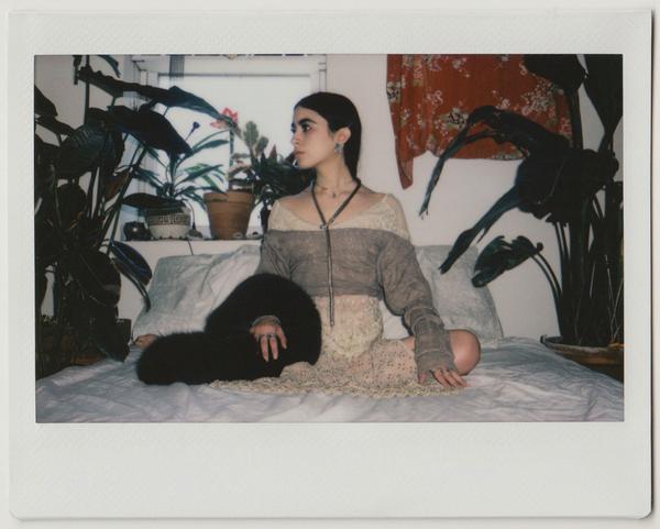 alex posing on their bed.