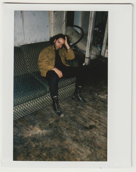 alex seated on couch.