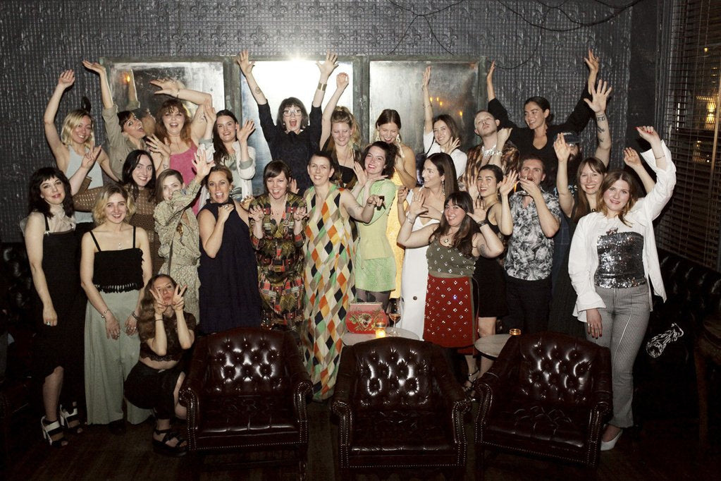beacon's partners and managers group smiling, hands raised, and high energy.