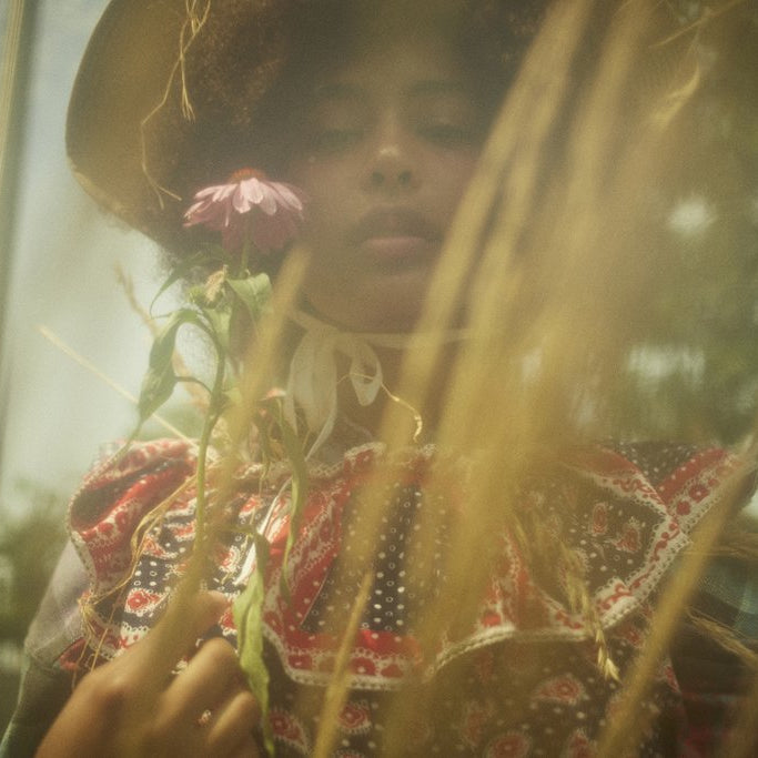 model portrait out of focus with flower.