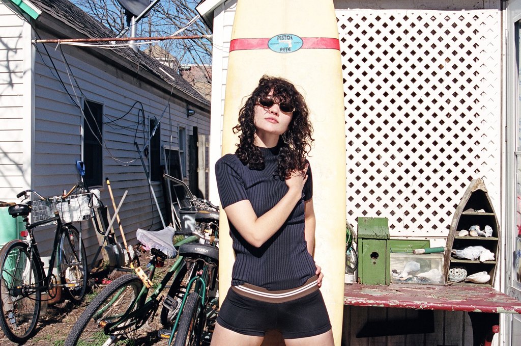 model posing with surfboard.