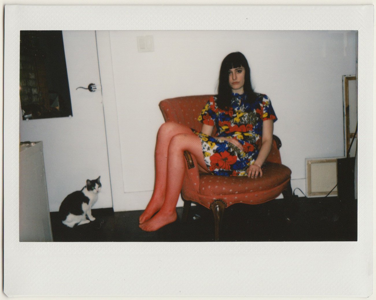 jessi in a chair with their cat.