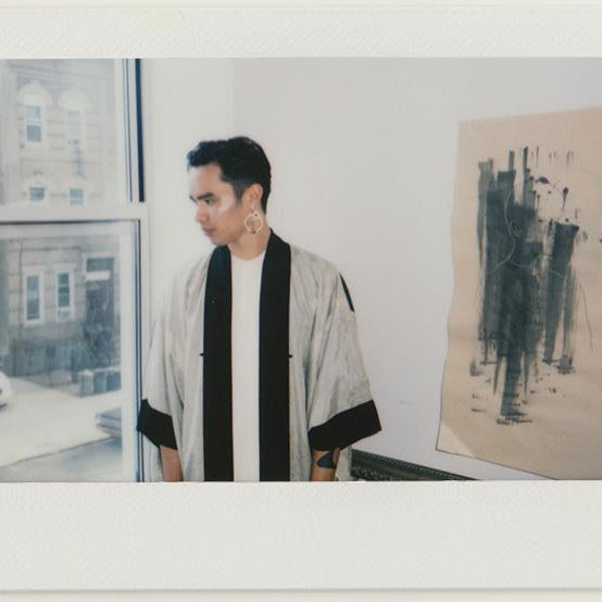 kashton in a kimono at their window.