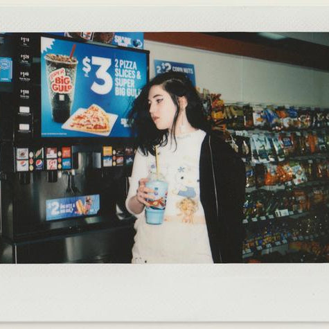 lucy standing in front of big gulp machine.