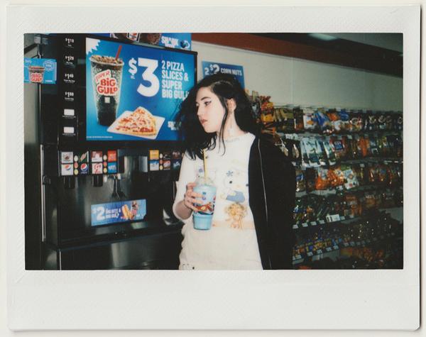 lucy standing in front of big gulp machine.