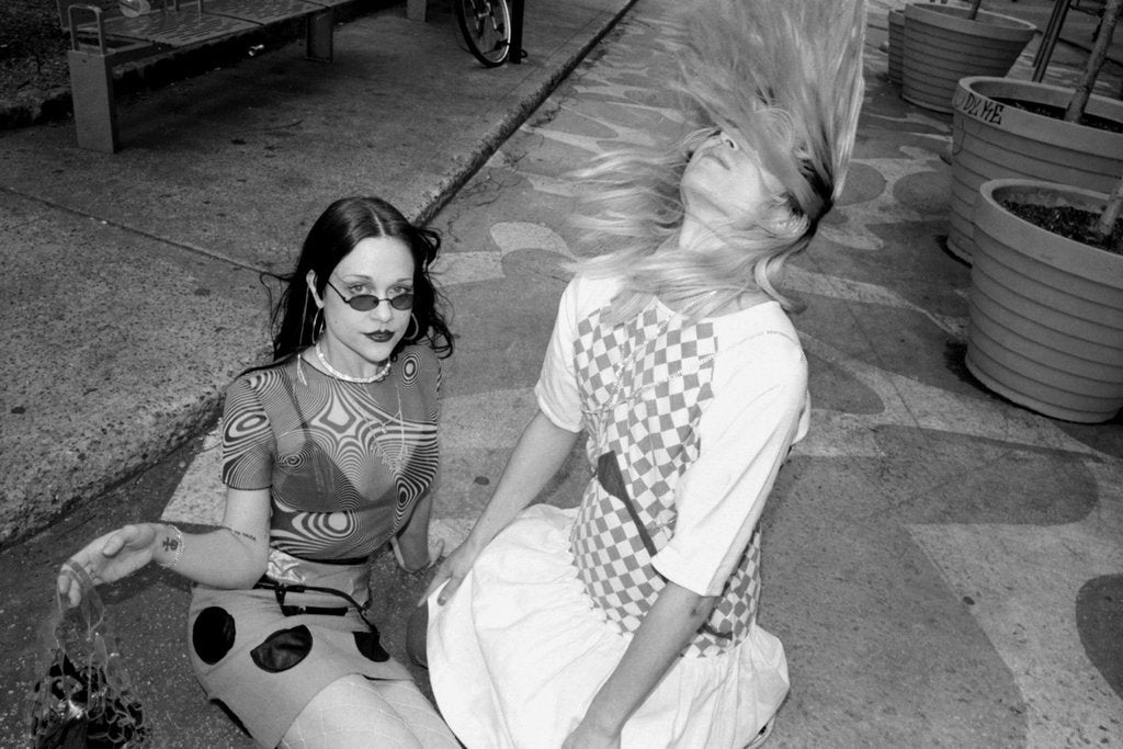 models posing on the road, one model flips their hair.