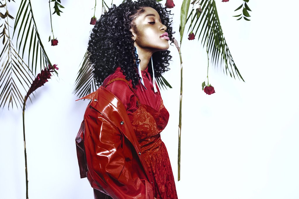 profile of model with roses and fronds.