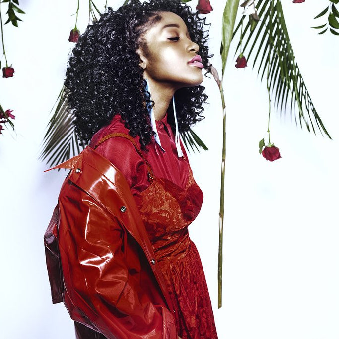 profile of model with roses and fronds. 