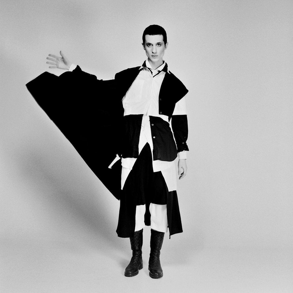 model posing in motion by flicking jacket.
