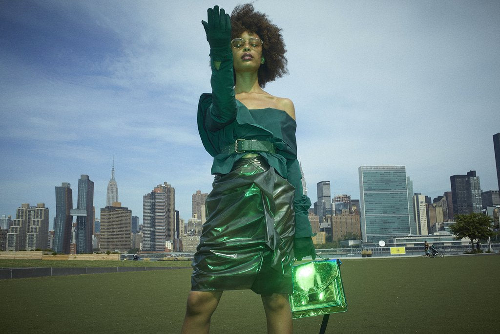 model in front of city skyline.