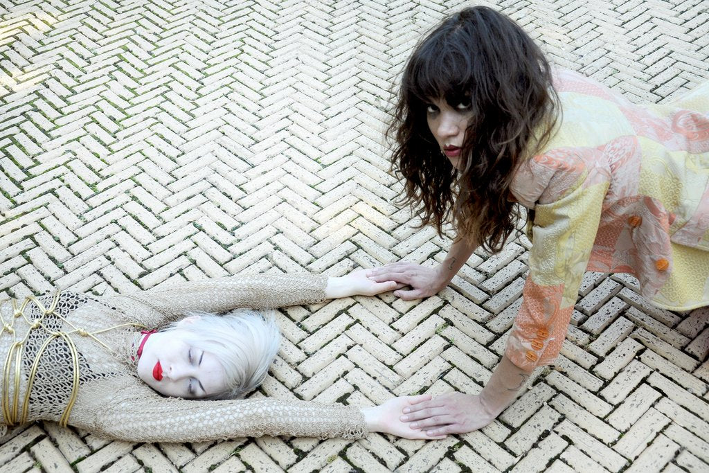 two models posing on the ground.