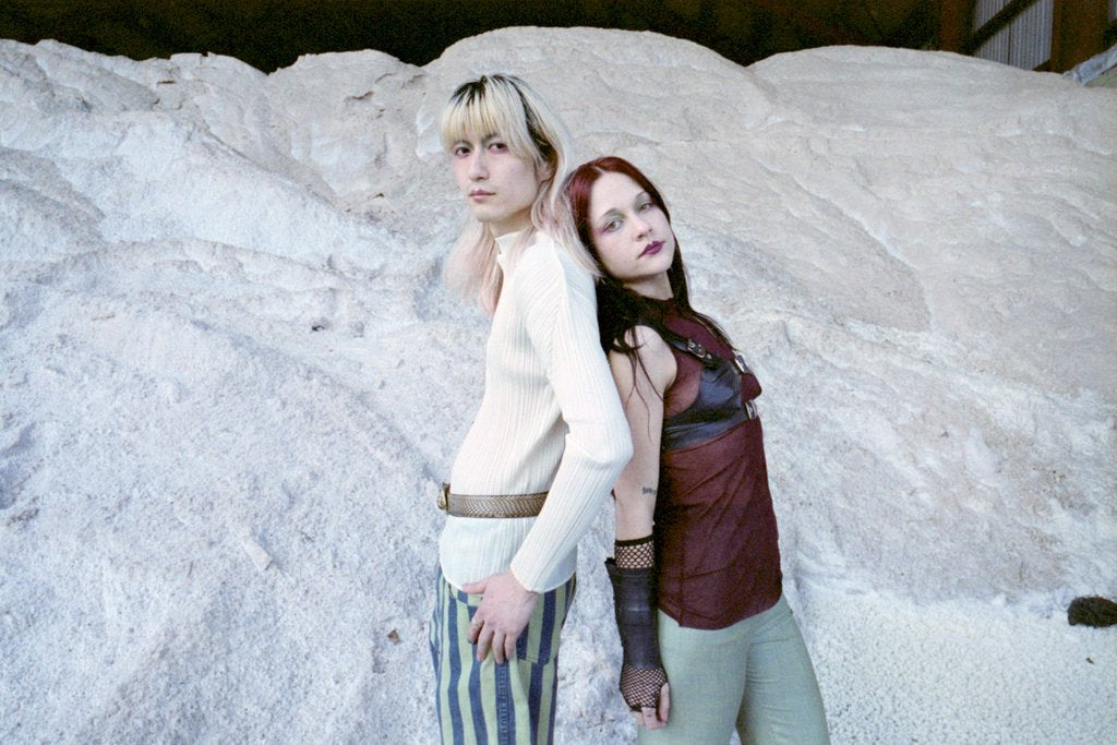 models posing in front of salt mound.