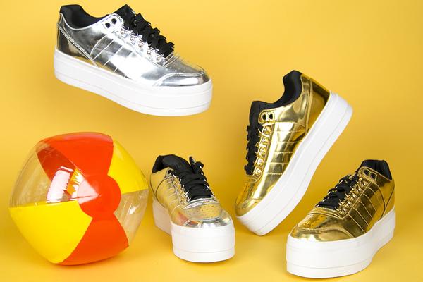 still life featuring beach ball and metallic platform sneakers.
