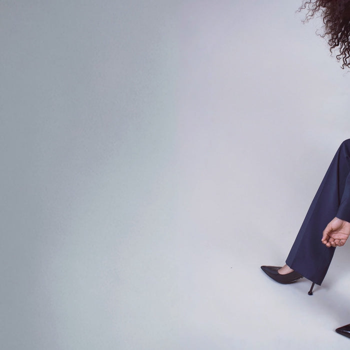 minimal studio shot of model posing in suit