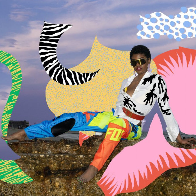 model in race pants and button up shirt on rocks at the beach with collage art added in post by dana. 