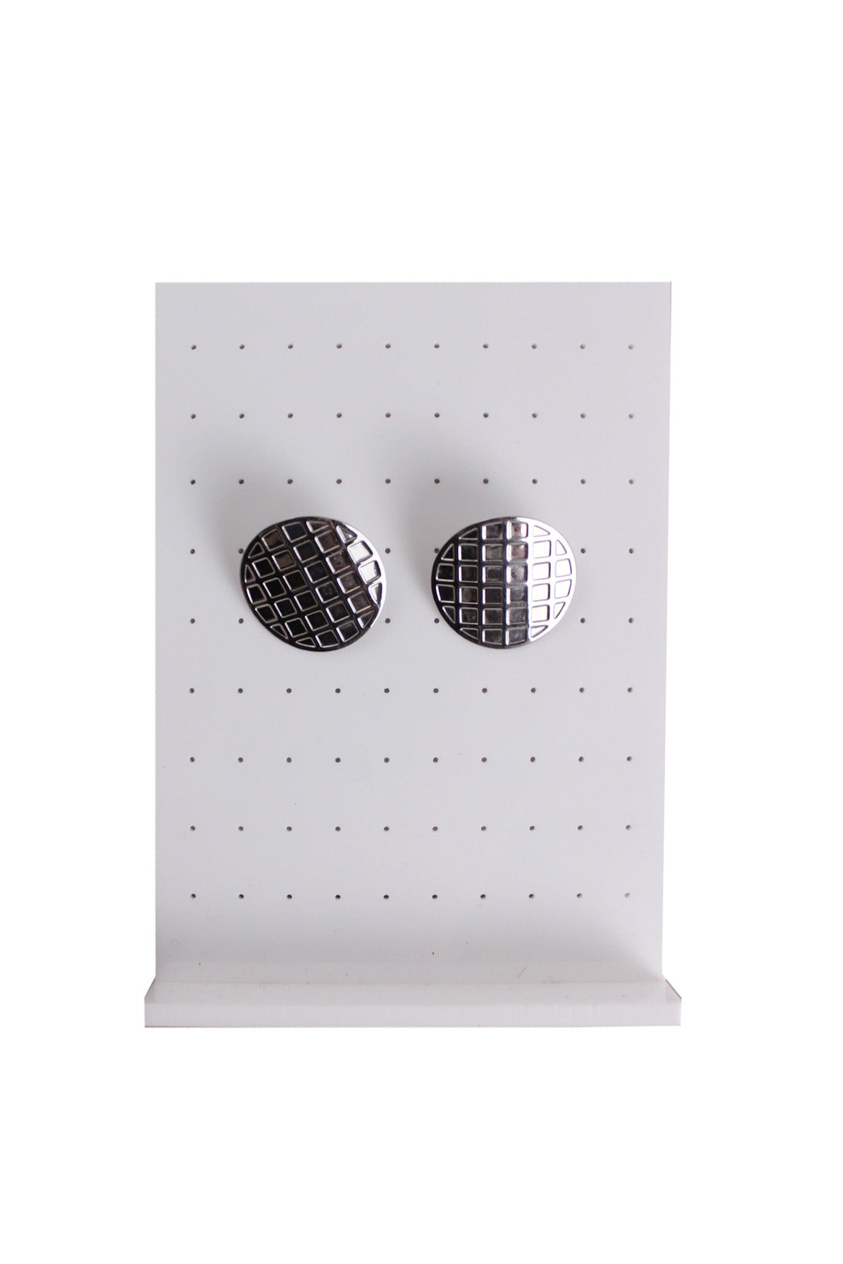 front of vintage silver rounded earrings. features rounded shape with checkered design.