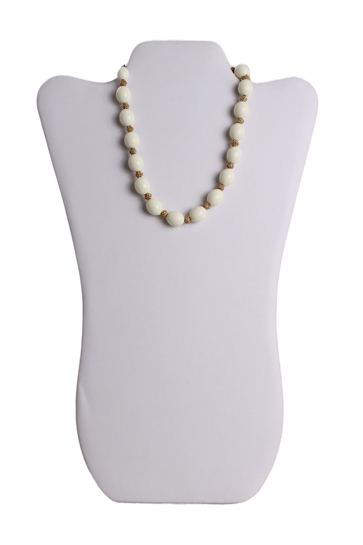 front of vintage trifari off white and gold toned bead necklace. features ovals and gold toned beads, and hook closure.