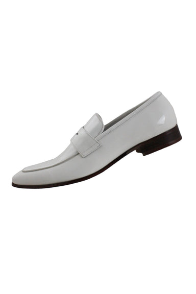 tilted side angle maurice by jc studio white patent leather penny loafers featuring tapered square toe, piping detail at upper, contrast sole, and 1" stacked heel.
