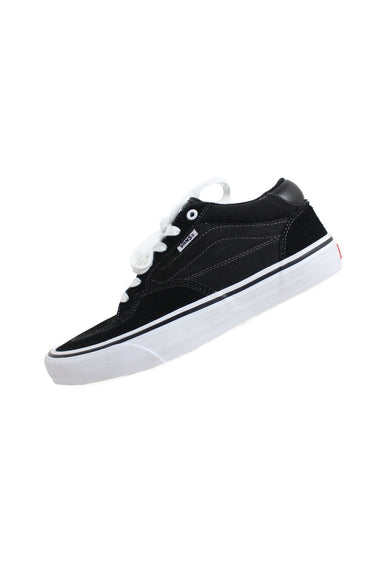 side angle of vans black leather and canvas rowan style skate shoes. features suede toe/heel, canvas side wall, branded white tag with text 'vans' beside lace closure, and white rubber sole.