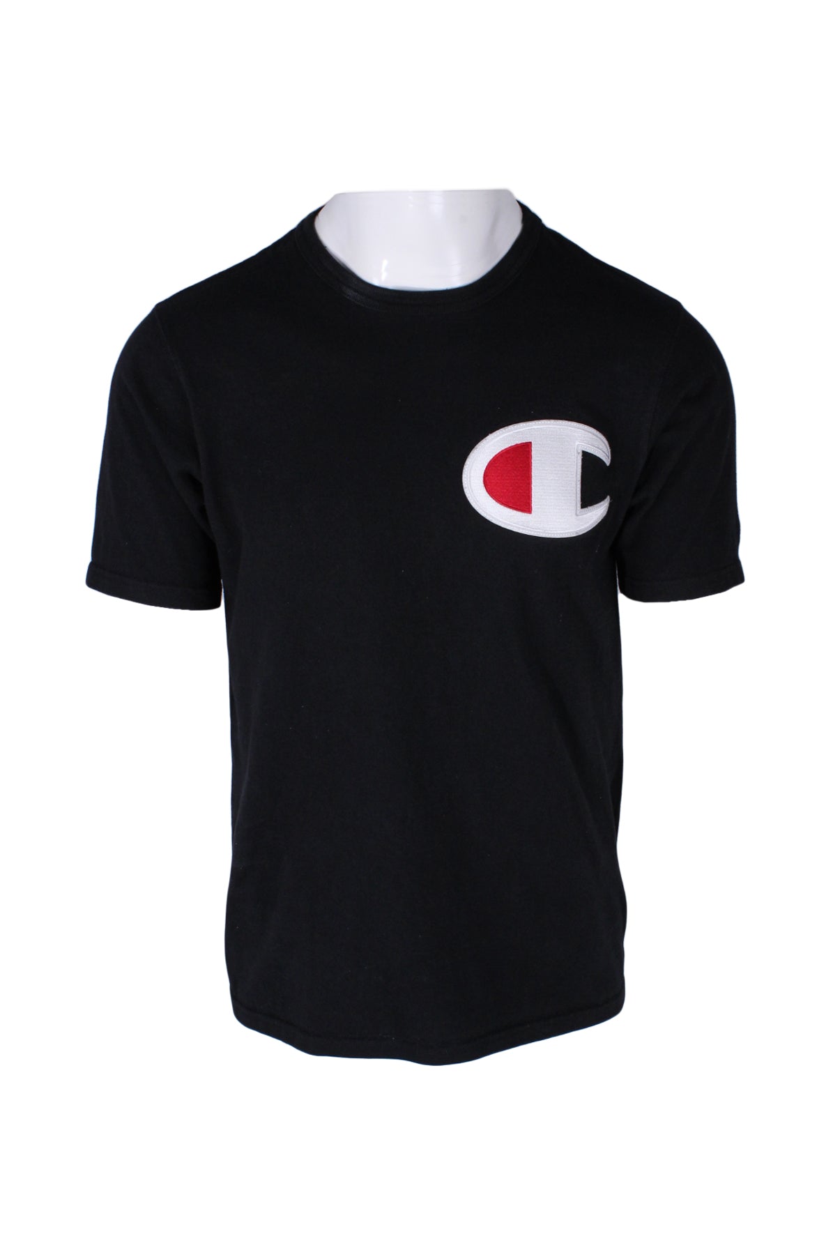 front angle champion black short sleeve cotton t-shirt on masculine mannequin torso featuring oversized white/red embroidered logo patch at left chest, blue/red/white embroidered logo patch at left sleeve, and rib knit crew collar.