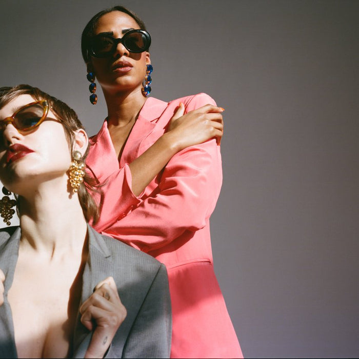 two models posing in tailored looks. 