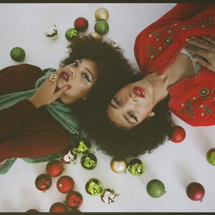 glam holiday looks on two models laying down. 